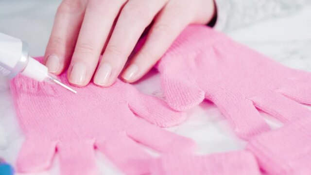 Rhinestone pink kids gloves with snowflake shapes.