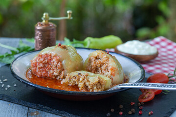 Green bell peppers stuffed with minced meat and rice in tomato sauce. Balkan food, homemade stuffed paprika.