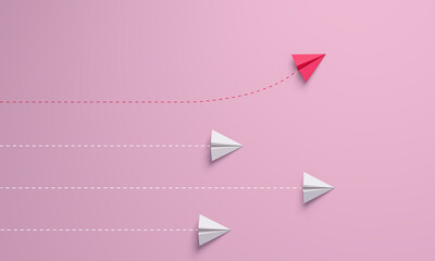 Women's disruption concept. Individual and unique leader pink paper airplane changing direction.
