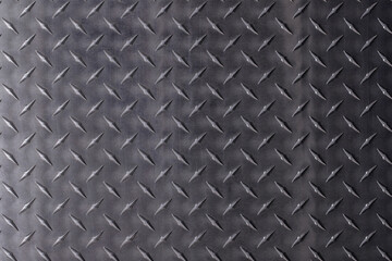 metal texture with diamond print. steel plate, dark gray background.