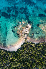 View from above, stunning aerial view of a green coastline with some empty beaches bathed by a beautiful and turquoise sea. Liscia Ruja,Sardinia, Italy.