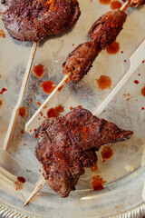 Close up of grilled hot chicken liver on skewer