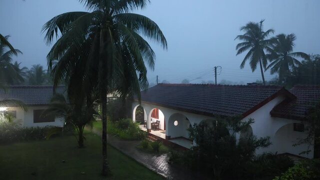 Night Thunderstorm rain tropical resort Ghana Africa. Heavy tropical rain storm, thunder and lightning. Torrential night storm caused flooding and blown down broken tree damage.