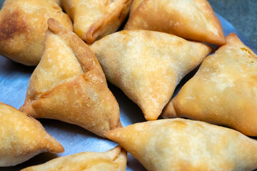 Homemade Samosa, samsa or smosa. A vegetarian spicy Indian special traditional street food. Iftaari dish, Selective focus.
