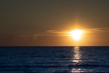 Sunset in the ocean. Beautiful seascape. Relaxation and summer beach vacation concept