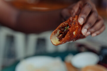 Close up of a hand holding a taco