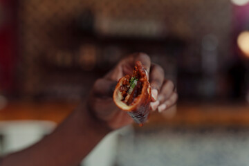 Close up of a hand holding a taco