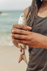 Freshly caught fish from the ocean being held in a person's hands
