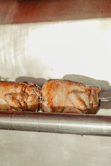 Whole chickens on a rotisserie 