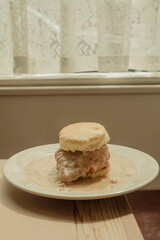 Fried chicken biscuit meal in front of kitchen window