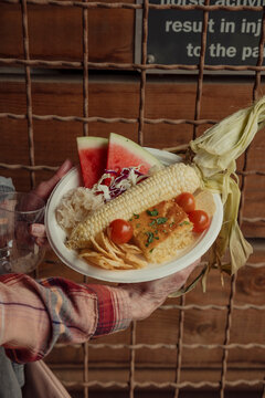 A summer plate of tomatoes, corn, watermelon and corn bread