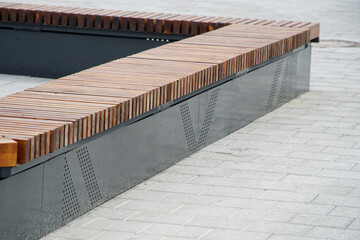 An example of installing a modern corner bench in an urban space. Alley or footpath