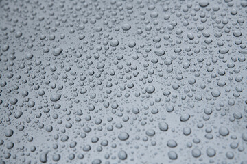 Wet metal surface after rain. Hydrophobic effect and water drops on car varnish after using ceramic coating