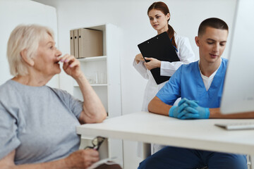 Fototapeta premium nurse and doctor communicating with woman patient health care