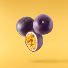 Fresh ripe passion fruit falling in the air