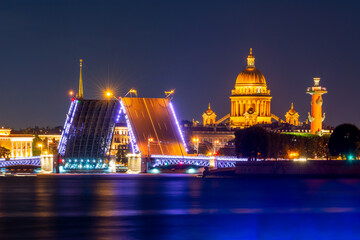 Fototapeta na wymiar Saint Petersburg cityscape with open Palace bridge, St. Isaac's cathedral, Admiralty building and Rostral column at night, Russia