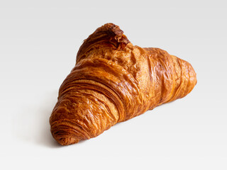 French croissant with a crisp golden crust on a white background