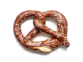 Pretzel sprinkled with sesame seeds on a white background