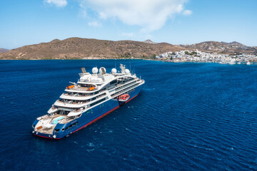 Cruise ship in port. Aerial view of the ship from drone. Blue clear water in the Mediterranean Sea. Summer vacation and travel on a cruise liner. Summer trip.