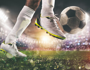 Close up of a soccer scene with player in a white uniform kicking the ball with power © alphaspirit