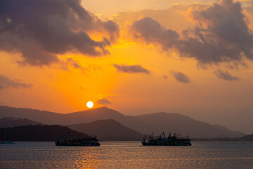 Sunset over the bay with fishing boats