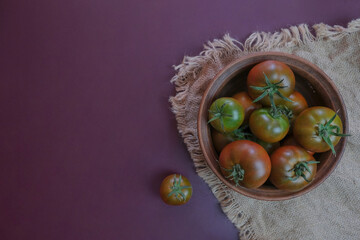 Fresh ripe and green tomatoes, just picked from the plant. Food background.
Organic tomatoes on a natural background. Collecting tomatoes.