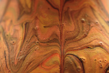 abstract background of deep orange, burnt orange, amber colors forming swirly, marbelized shapes looking like lava