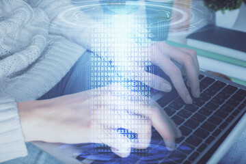 Double exposure of woman hands working on computer and data theme hologram drawing. Tech concept.