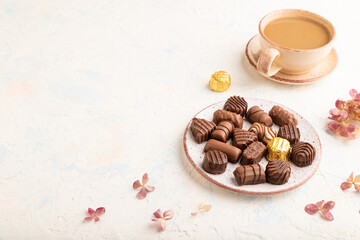 Chocolate candies with cup of coffee. side view, copy space.
