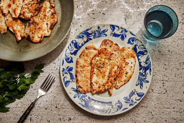 Dish with freshly cooked marinated breast fillets under sunlight