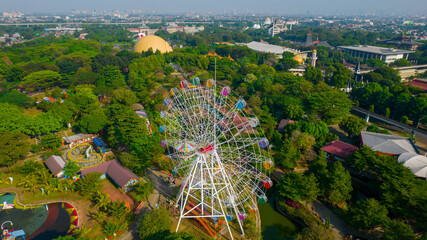 Aerial view of Ferris wheel which is located on the Taman legenda at a Taman Mini Indonesia Indah with noise cloud. Jakarta, Indonesia