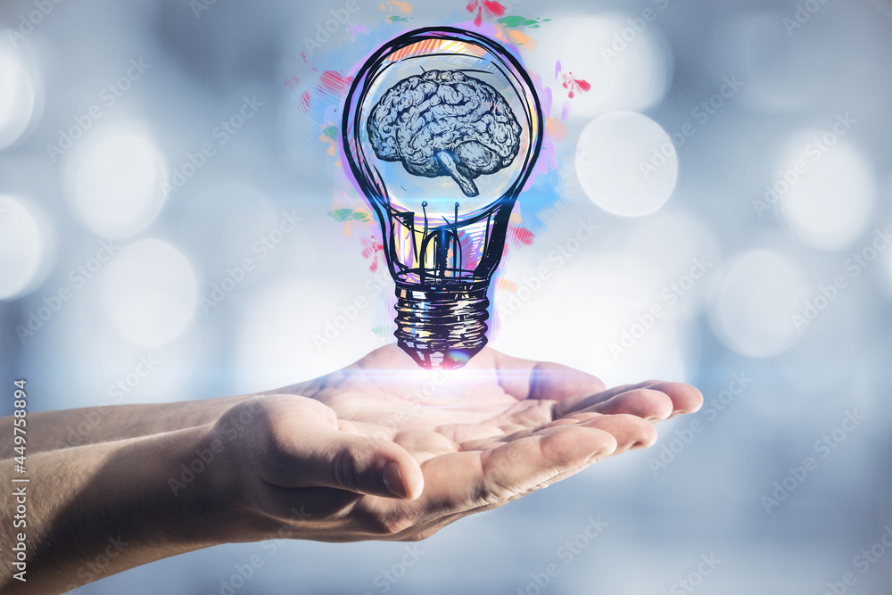 Poster hand holding light bulb sketch on blurry bokeh background. idea and inspiration concept.