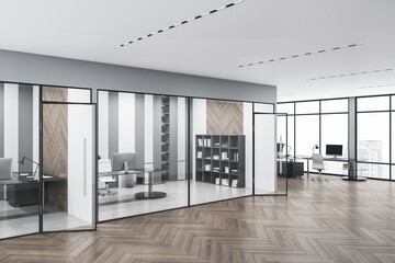 Spacious concrete glass office interior with daylight and wooden flooring. Workplace design...