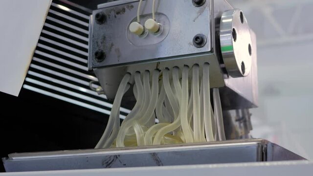 Waste plastic recycling machine: process of melting polyethylene at plant, factory - close up view. Environmental protection, industrial, automated technology concept