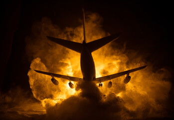 Air Crash. Burning falling plane. The plane crashed to the ground. Decorated with toy at dark fire...