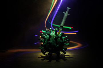 Coronavirus 2019-nCov novel coronavirus concept. Big Corona virus miniature model on wooden table with fog and backlight. Creative artwork decoration. Selective focus.