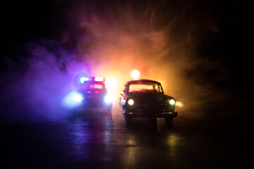 Police car chasing a car at night with fog background. 911 Emergency response police car speeding...
