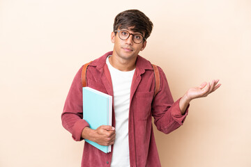 Young student caucasian man isolated on ocher background having doubts while raising hands
