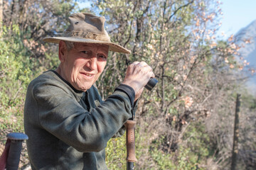 bird watching octogenarian locking for mountain birds