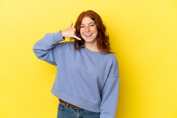 Teenager reddish woman isolated on yellow background making phone gesture. Call me back sign