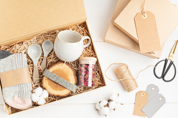 Preparing care package, seasonal gift box with plastic free, zero waste products. Personalized eco friendly basket for family and friends for christmas, thanksgiving, mothers day