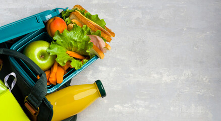 Lunch box, school and office supplies on a light background. Back to school concept. Social...