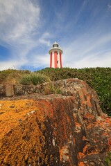 a close up of a large rock and lighthouse
