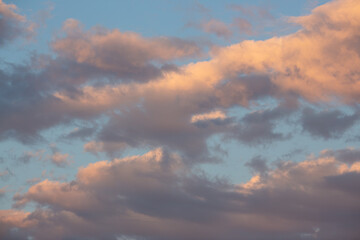 Naklejka na ściany i meble Beautiful sunset sky background with clouds. Scenic cloudscape.