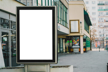 Blank mock up of vertical street poster billboard on city background. Advertising. Outdoor....