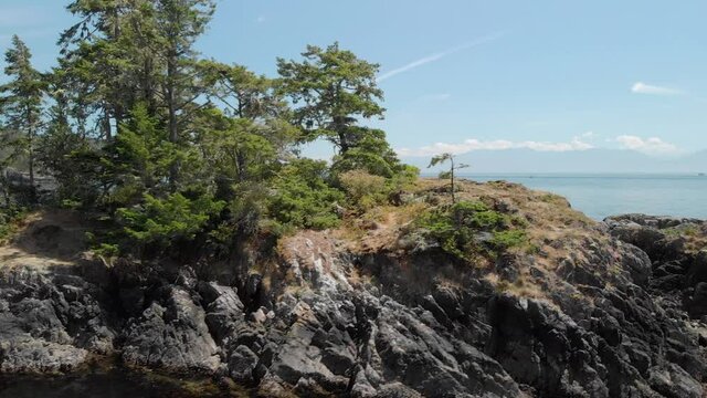 A aerial drone shot of the beautiful coastline with turquoise water near Sooke, BC. 4K 24FPS.