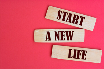The words Start a new life write on wooden blocks.