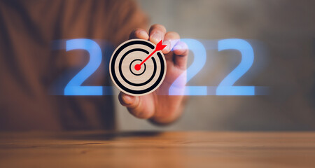 New year 2022 and goal or target icon. concept of New year Business goals and vision. businessman...