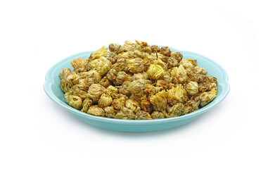 Chrysanthemum tea in ceramic dish isolated on white background. Chrysanthemum tea is a flower-based infusion beverage made from chrysanthemum flowers which are most popular in East and Southeast Asia