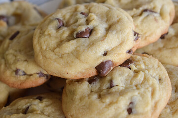 Closeup shot of stacked, freshly baked chocolate chip cookies on a plate 